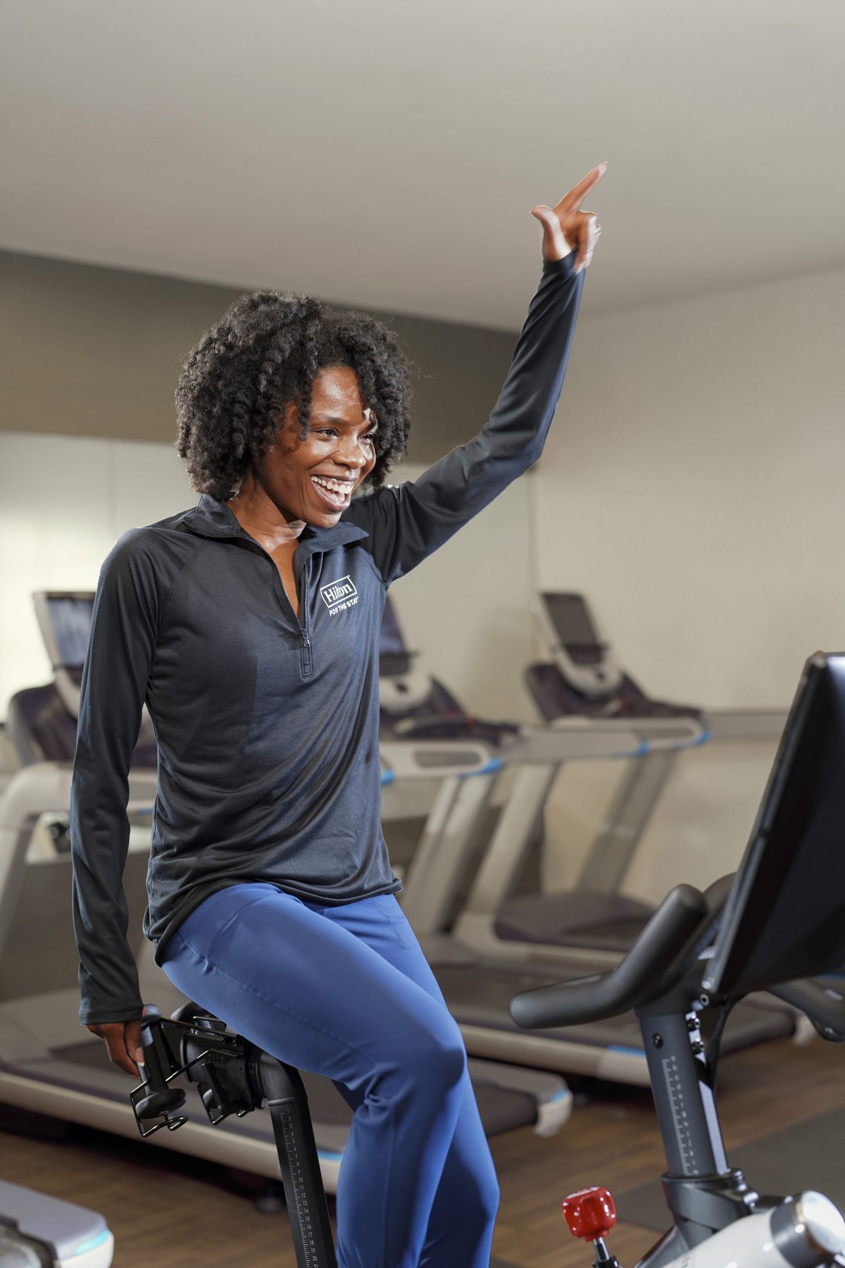 Woman riding Peloton bike at Hilton
